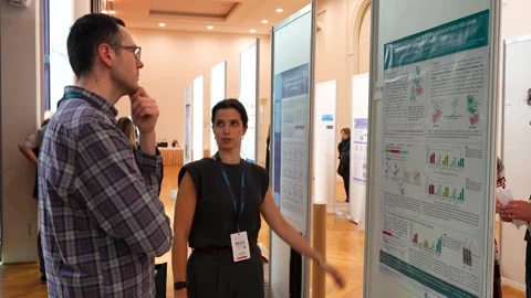 Scientist Explaining Research Poster at Conference Stock Footage 334776340