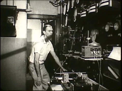 A scientist explains a big motor generator sending currents to electromagnets, Stock Footage 75267530