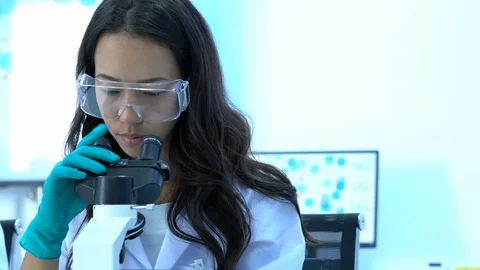 Scientist female is looking through microscope. Video stock 108631223