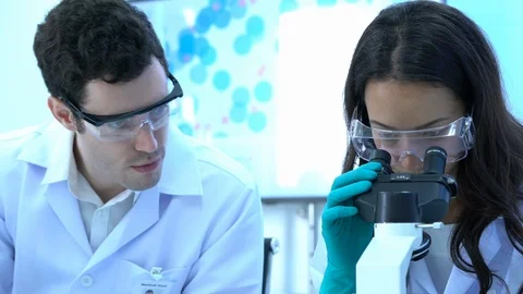 Scientist female is looking through microscope. Stock Footage 108638385
