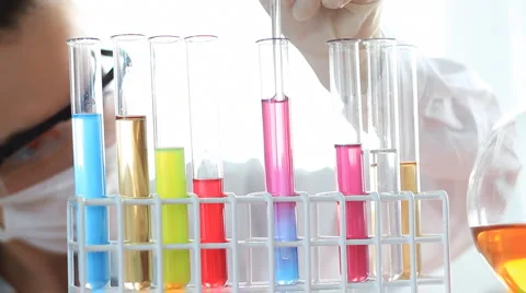 Scientist female mixing chemicals in test tube HD Stock Footage