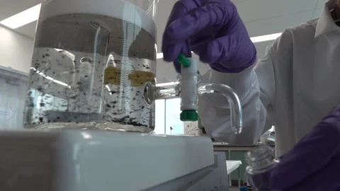 Scientist filling a test tube Stock Footage 106901556