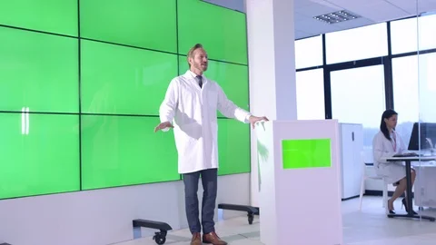 Scientist giving lecture in front of green screen display in office Stock Footage 108180551