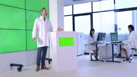 Scientist giving lecture in front of green screen display in office Stock Footage 108180879
