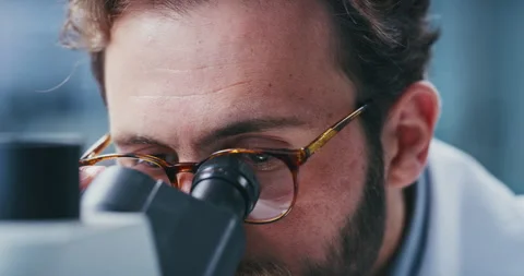Scientist, glasses and man with microscope, lab and analysis for vaccine, vision Stock Footage 330038936
