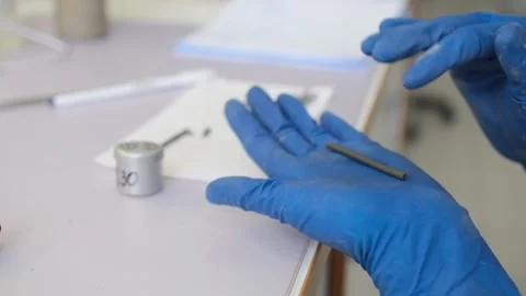 A scientist in gloves prepares soil samples for research. Clay Stock Footage 231739690