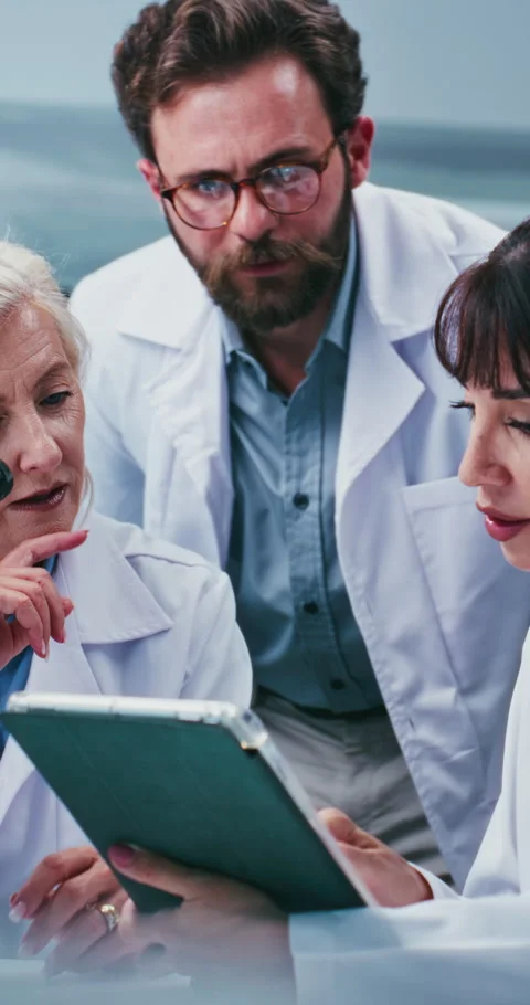 Scientist, group and tablet for report at laboratory with talk, feedback or Stock Footage 331513559