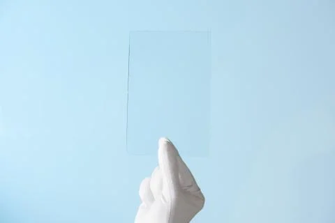 Scientist hand in glove show rectangle piece of new research prototype of tra Foto stock