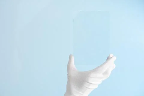 Scientist hand in glove show rectangle piece of new research prototype of tra Foto stock