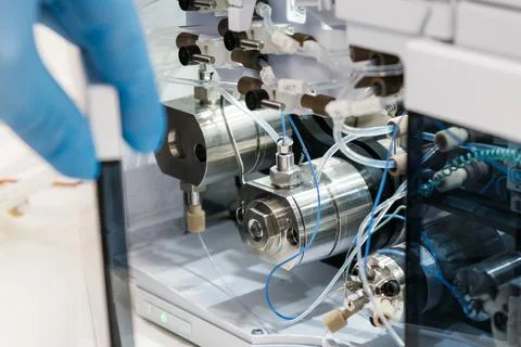 Scientist hand opens the door with binary pump for mixing for HPLC gradient Stock Photos