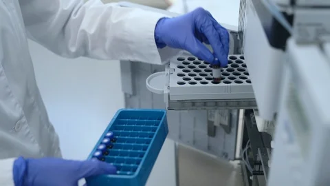 Scientist hand putting test tubes ampoules bottles in pcr machine Spbas. dna Stock Footage 128968388