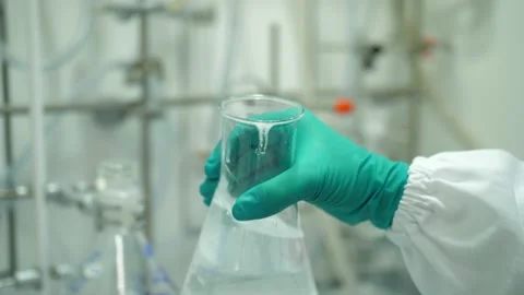 Scientist hand shaking Erlenmeyer flask in laboratory 4k Stock Footage 142489509