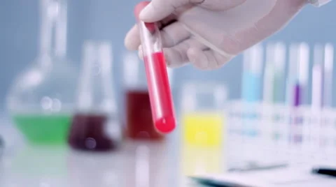 Scientist hand shaking test tube with red substance HD Stock Footage 2808024