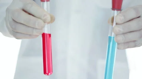 Scientist hand showing test tubes with with blue and red substance HD Stock Footage