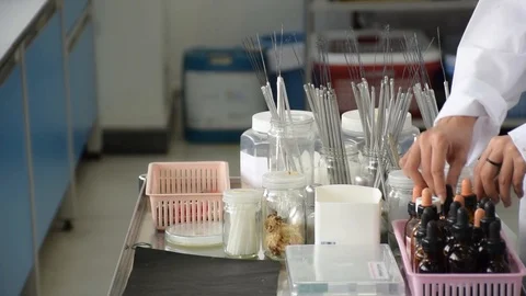 Scientist hand sorting science lab equipment tool in research laboratory Stock Footage 85495172