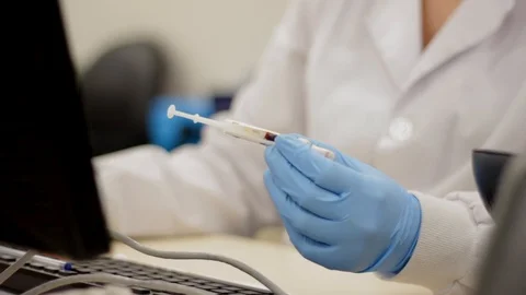 Scientist hands holding blood sample Stock Footage 130138888