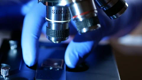 Scientist hands with microscope close-up shot in the laboratory. Medical labo Видео 107842813