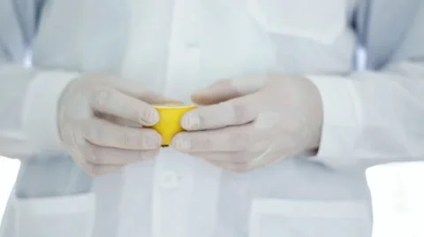 Scientist hands in rubber gloves examining lemon HD Stock Footage