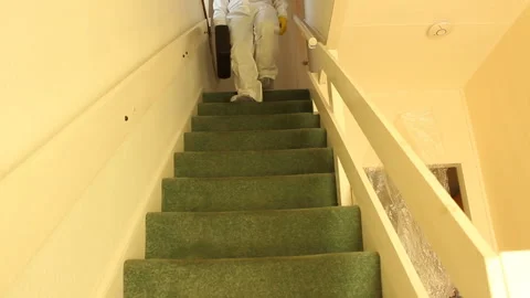 Scientist in hazmat suit going down stairs with a suitcase-no visible face Stock Footage 135722333