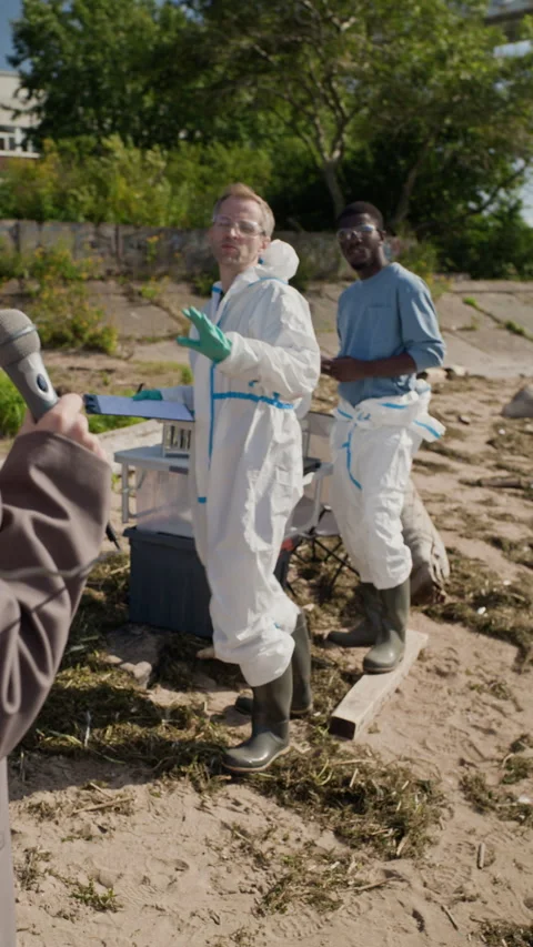 Scientist in Hazmat Suit Refusing Interview to Journalist Stock Footage 344720582