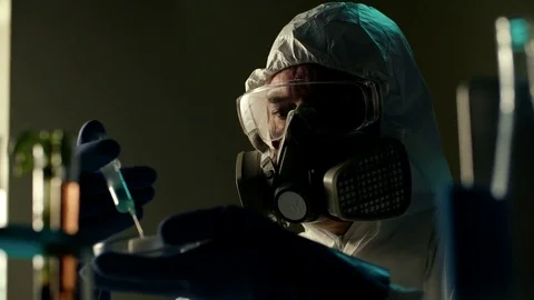 Scientist in heavy full protected clothes performs dangerous hazardous Stock Footage 72145406