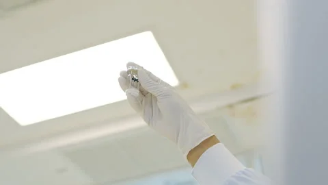 Scientist hold transparent white solution in small bottle in laboratory Vídeos de archivo 158527694