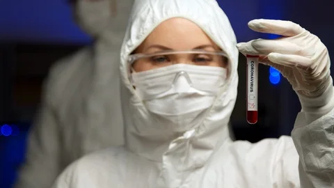 Scientist holding Coronavirus test sample Stock Footage 127560250