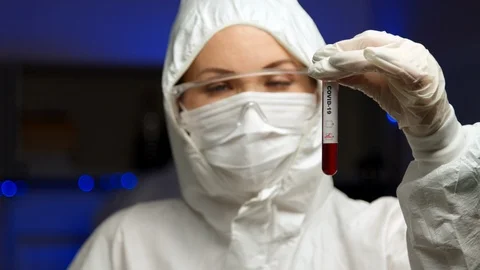 Scientist holding COVID-19 test sample Stock Footage 127560157