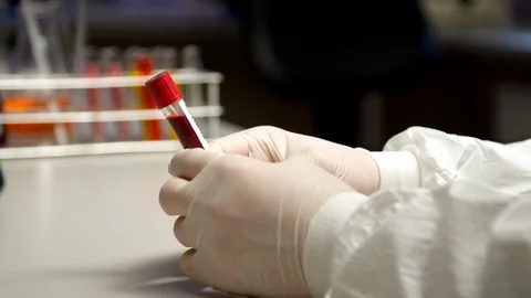 Scientist holding COVID-19 test tube Stock Footage 127561704