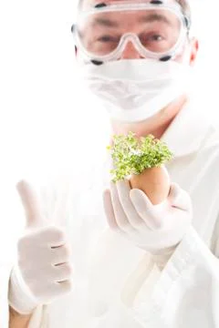 Scientist holding cress in egg shell with thumbs up, close up Stock Photos