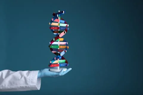 Scientist holding DNA structure model on dark blue background, closeup. Spa.. Stockfoto's