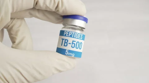 Scientist holding peptide tb-500 vial on white background Stock Footage 345009705