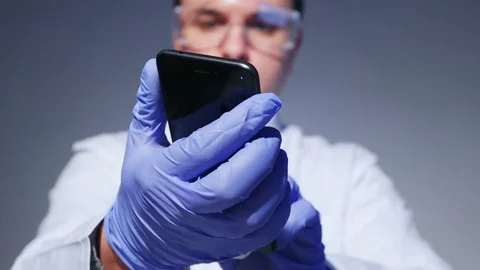 Scientist is holding a smartphone Stock Footage 84413613