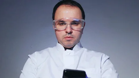 Scientist is holding a smartphone Stock Footage 84415457