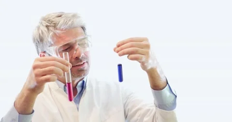 A scientist holding two test tubes, the result of the water hardness test 스톡 동영상 48982929