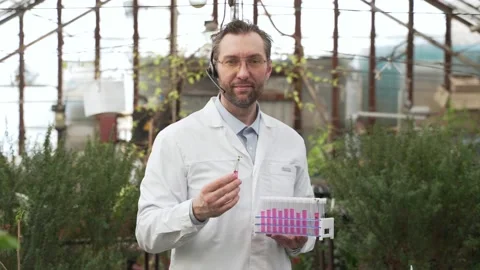 Scientist holds test tubes with plants in his hands. Bioengineering, GMOs Stock Footage 186446620