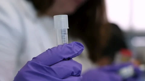 The scientist holds a white plastic test tube in his hand Stock-Footage 171520313