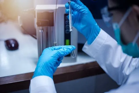 Scientist inject sample with micro syringe to TOF Mass Spectrometer for ana.. Stock Photos