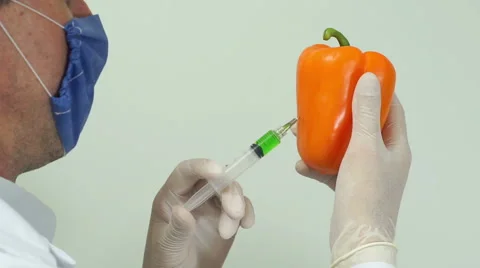 Scientist Injecting Pepper Over Shoulder Video stock 64215296