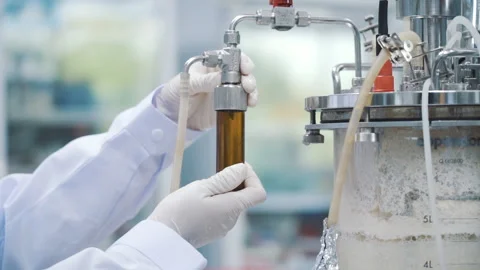 Scientist insert brown glass bottle into laboratory machine close up Stock-Footage 158834244