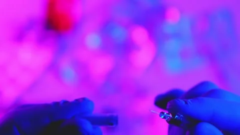Scientist inserting a syringe needle into a vial Stock-Footage 346244841