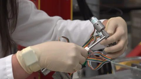 Scientist inspects a gadget Stock Footage 106900595