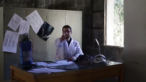 Scientist inventor  works in his laboratory. Stock Footage 103453473