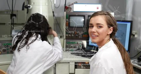 Scientist in lab coat adjusting electron microscope at lab bench, chemical Stock Photos