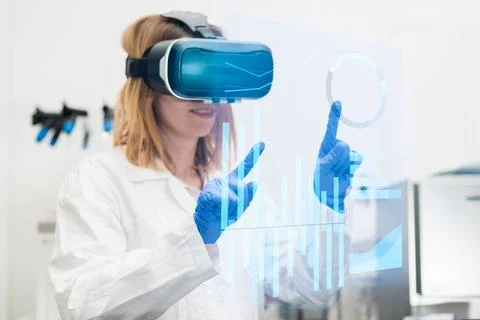 Scientist in lab coat and virtual reality VR goggle uses AR augmented reality Stock Photos