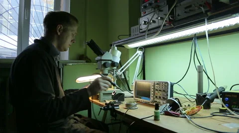 Scientist in the lab looking into a microscope Stock Footage 42820824