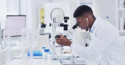 Scientist, lab or black man with microscope for medical research, forensic .. Fotos de archivo