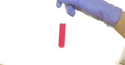A scientist in a lab shaking and mixing some red chemicals in a test tube Stock Footage 48985590