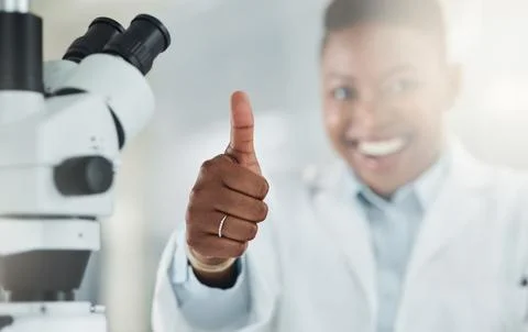 Scientist, laboratory and thumbs up with microscope for medical analysis, r.. Stock Photos