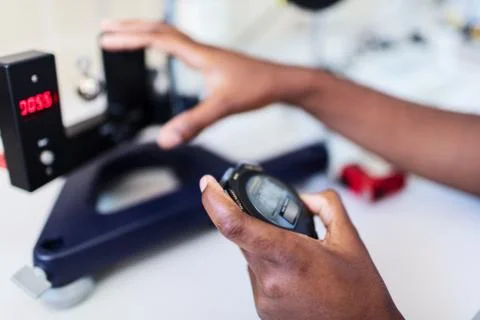Scientist with laboratory clock and timer. Stock Photos